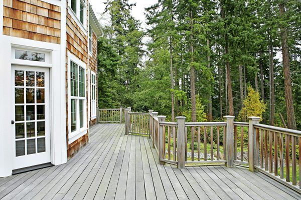 Wooden deck on house near forest